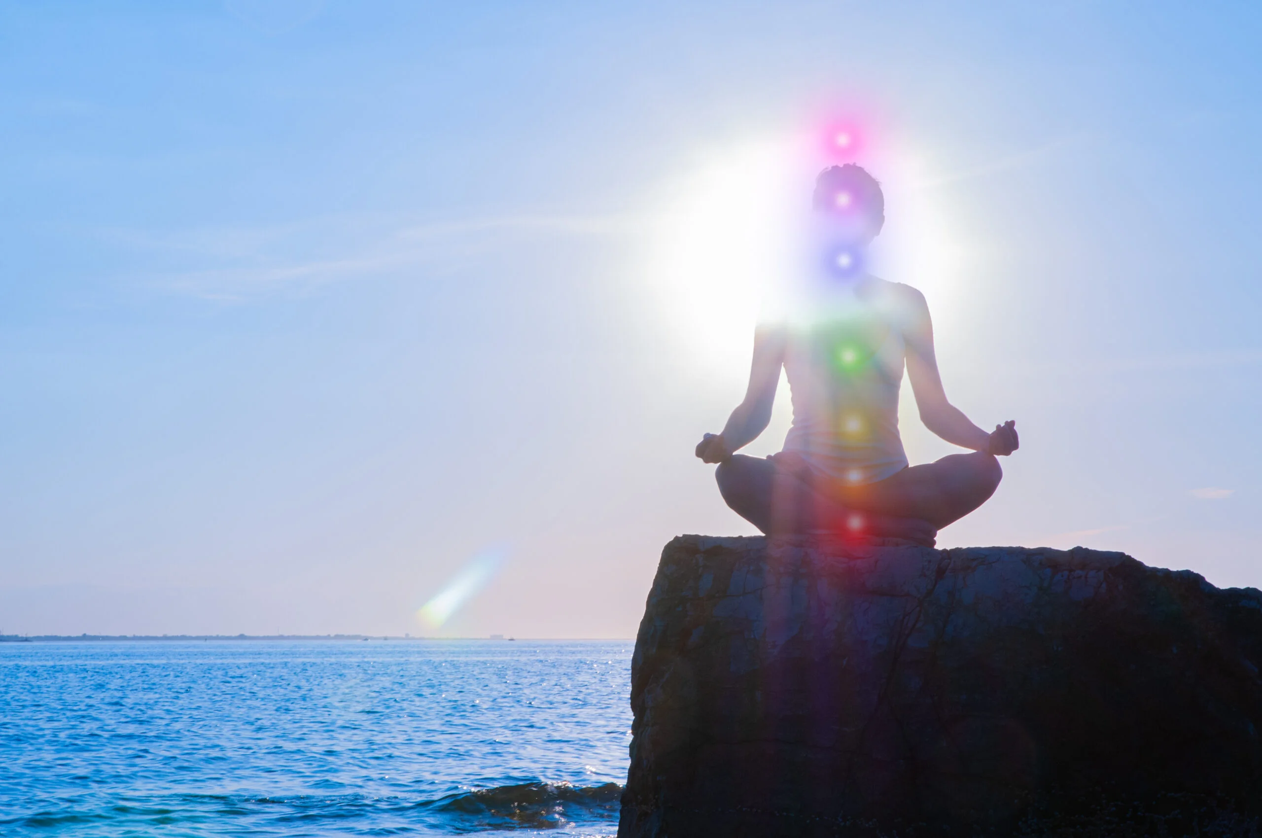 Woman,Is,Meditating,With,Glowing,Seven,Chakras,On,Stone,At Woman,Is,Meditating,With,Glowing,Seven,Chakras,On,Stone,At